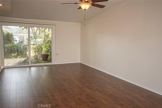 empty room with vaulted ceiling, ceiling fan, and dark hardwood / wood-style flooring