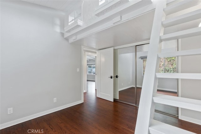 unfurnished room with dark hardwood / wood-style flooring