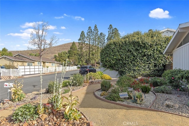 view of yard with a mountain view and fence