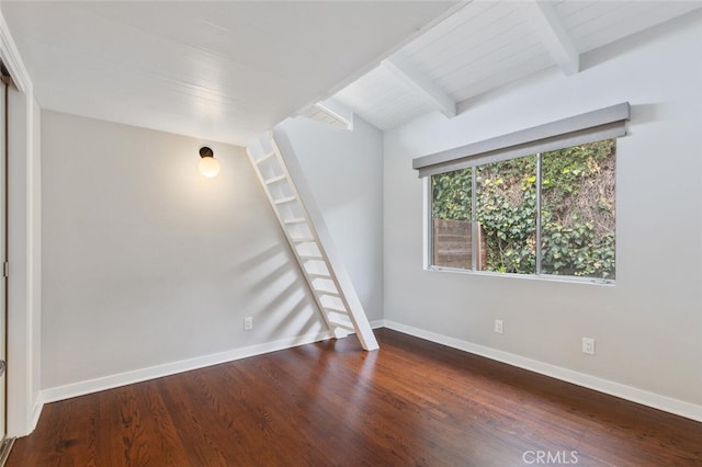 empty room with beamed ceiling, baseboards, and dark wood finished floors