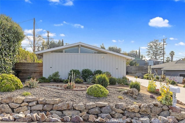 view of side of property featuring fence and board and batten siding