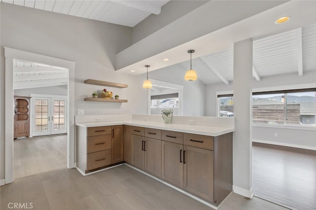 kitchen with wooden ceiling, hanging light fixtures, french doors, light hardwood / wood-style flooring, and vaulted ceiling with beams