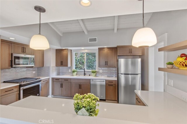 kitchen with sink, beamed ceiling, tasteful backsplash, appliances with stainless steel finishes, and pendant lighting