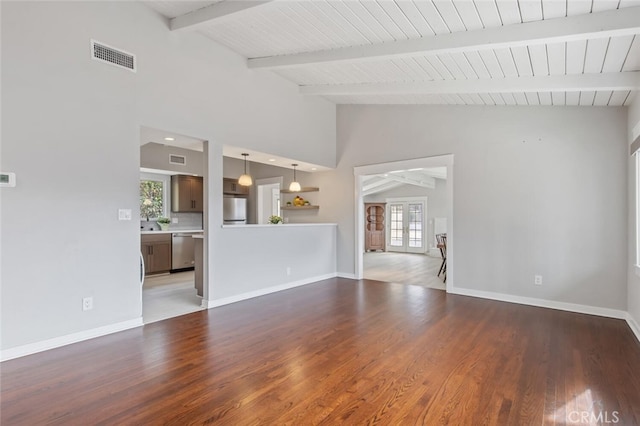 unfurnished living room featuring french doors, vaulted ceiling with beams, and dark hardwood / wood-style flooring