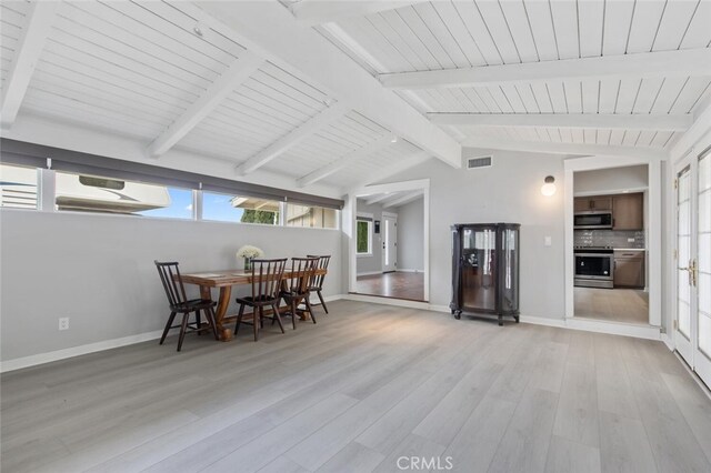 dining space with wooden ceiling, light hardwood / wood-style flooring, and vaulted ceiling with beams