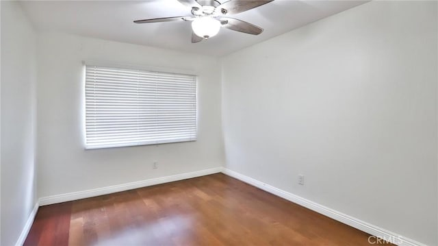 unfurnished room featuring ceiling fan and dark hardwood / wood-style flooring