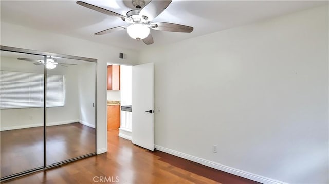 unfurnished bedroom featuring a closet, hardwood / wood-style flooring, and ceiling fan