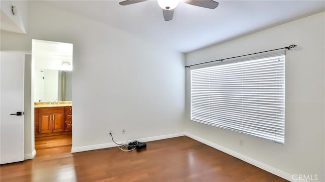 empty room featuring hardwood / wood-style flooring, sink, plenty of natural light, and ceiling fan