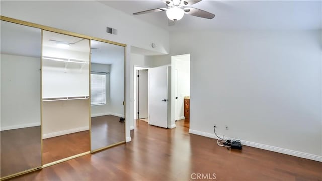 unfurnished bedroom with ceiling fan, a closet, and wood-type flooring