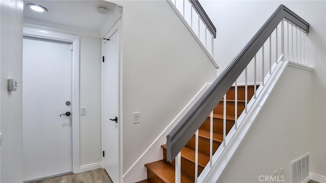 stairs featuring wood-type flooring