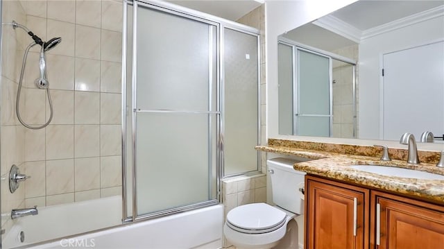 full bathroom featuring combined bath / shower with glass door, vanity, crown molding, and toilet