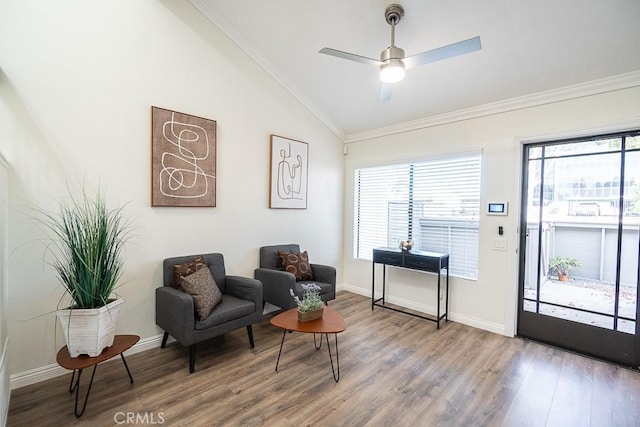 sitting room with ceiling fan, lofted ceiling, hardwood / wood-style floors, and crown molding