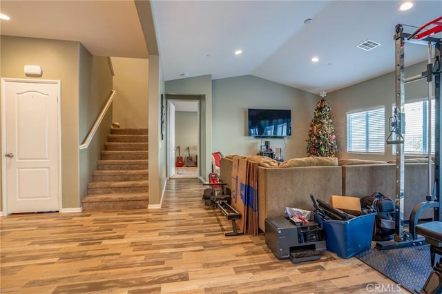 living room featuring vaulted ceiling and light hardwood / wood-style floors