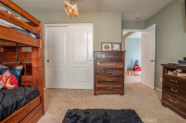 bedroom featuring light carpet and a closet