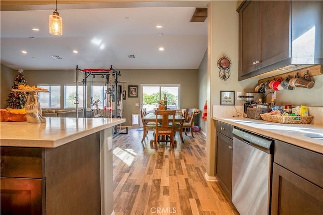 kitchen with dishwasher, hanging light fixtures, vaulted ceiling, light hardwood / wood-style flooring, and dark brown cabinetry