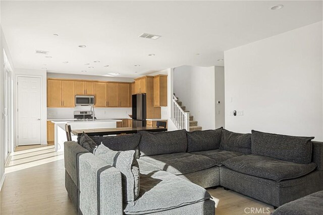 living room with light hardwood / wood-style flooring