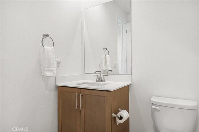 bathroom featuring toilet and vanity