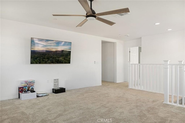 unfurnished room featuring ceiling fan and light carpet