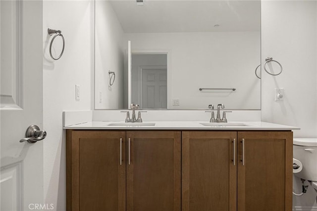 bathroom featuring toilet and vanity