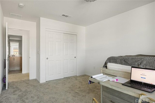 bedroom featuring a closet and light carpet