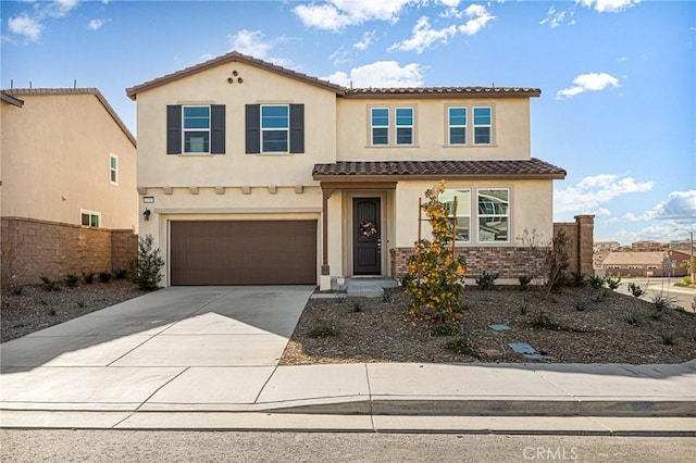 view of front of property featuring driveway, a tiled roof, and stucco siding