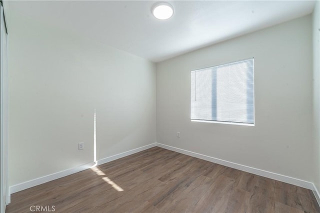 empty room with hardwood / wood-style floors