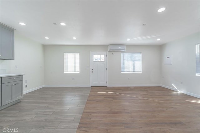 foyer featuring plenty of natural light and a wall mounted air conditioner