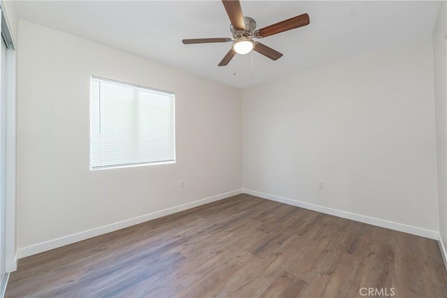 spare room featuring ceiling fan and hardwood / wood-style flooring