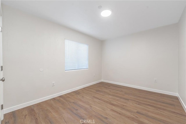 empty room with hardwood / wood-style floors