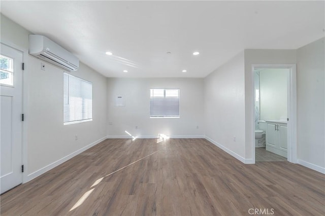 interior space featuring a wall mounted AC and dark wood-type flooring