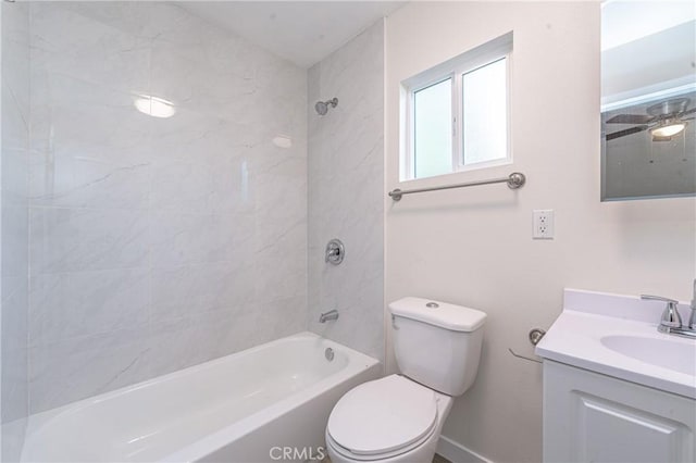 full bathroom featuring toilet, tiled shower / bath, and vanity