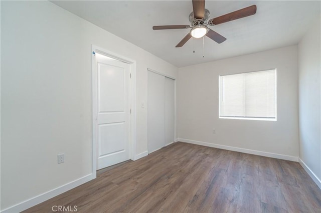 unfurnished bedroom with ceiling fan and wood-type flooring