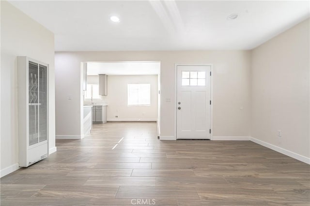 entryway with hardwood / wood-style floors