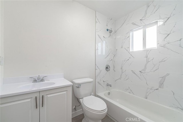 full bathroom with toilet, tiled shower / bath, and vanity