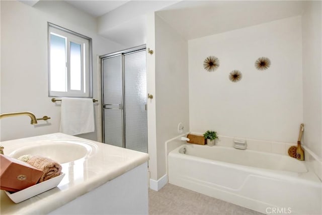 bathroom with vanity and shower with separate bathtub