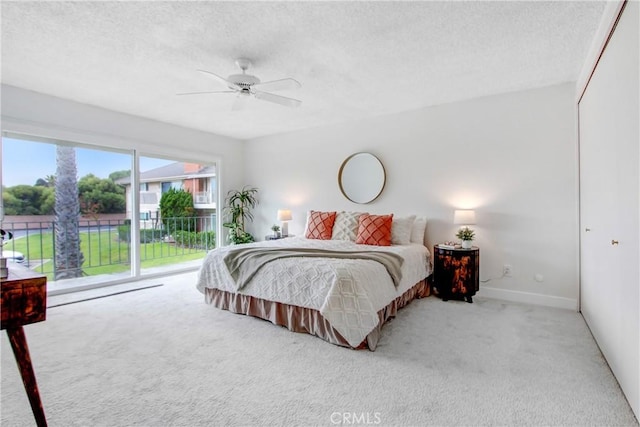 bedroom featuring ceiling fan, access to exterior, a closet, and light carpet