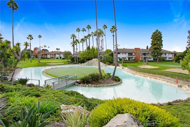 view of property's community featuring a water view and a yard