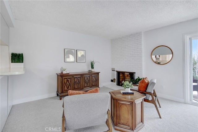 carpeted living room with a textured ceiling and a brick fireplace