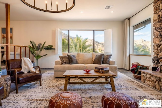 carpeted living room with an inviting chandelier and a mountain view