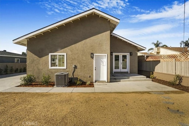 back of property featuring french doors, a patio, and cooling unit