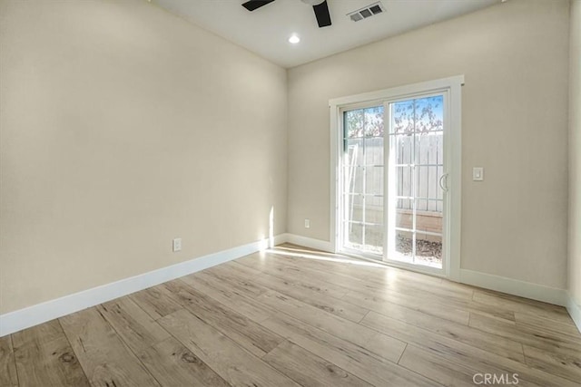 spare room featuring ceiling fan and light wood-type flooring