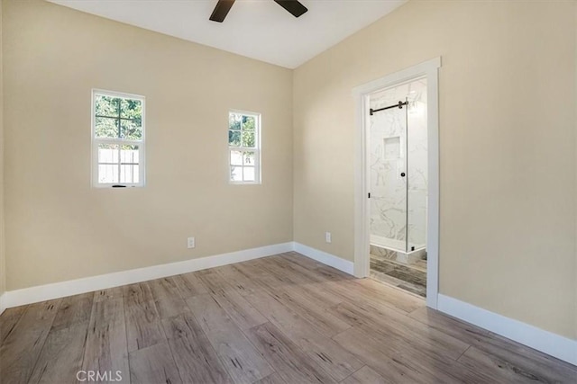 unfurnished room featuring ceiling fan and light hardwood / wood-style floors