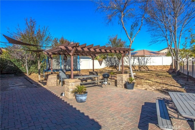 view of patio / terrace with a fenced backyard, a trampoline, grilling area, and a pergola