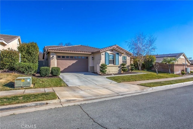 view of front of house featuring stucco siding, driveway, a front yard, a garage, and a tiled roof