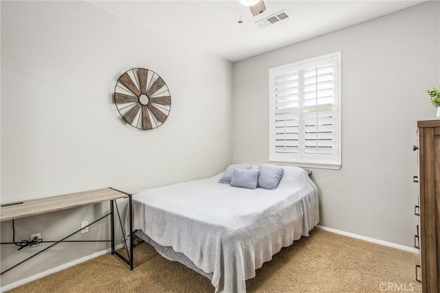 carpeted bedroom with ceiling fan, baseboards, and visible vents