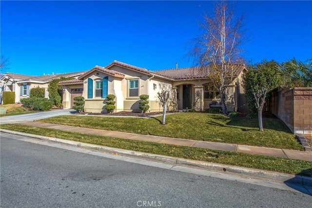 view of front of house with a garage and a front lawn