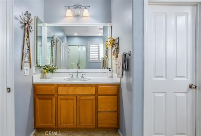 bathroom featuring an enclosed shower and vanity