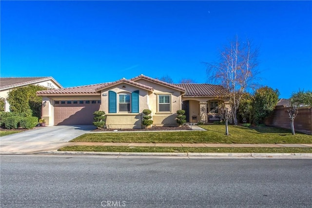 mediterranean / spanish-style home with a garage and a front yard