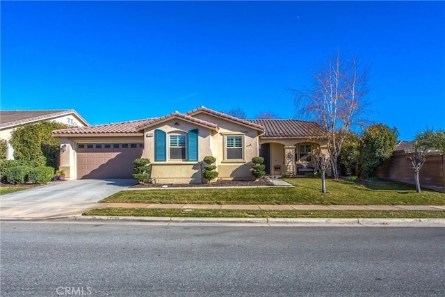 view of front of house with a garage, stucco siding, a tiled roof, and a front lawn