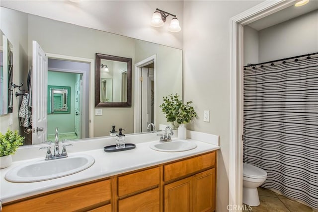 bathroom with tile patterned floors, toilet, vanity, and a shower with shower curtain